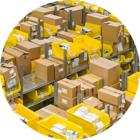 Warehouse shelves filled with numerous brown cardboard boxes and bright yellow plastic bins, organized in rows.